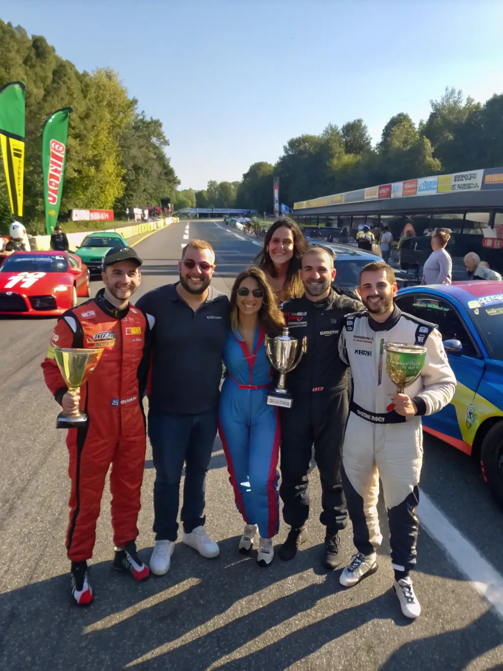 A photo of a diverse group of people participating in an inclusive motorsport activity organized by TEAM MECA ' DDICTION, demonstrating the organization's commitment to inclusivity.